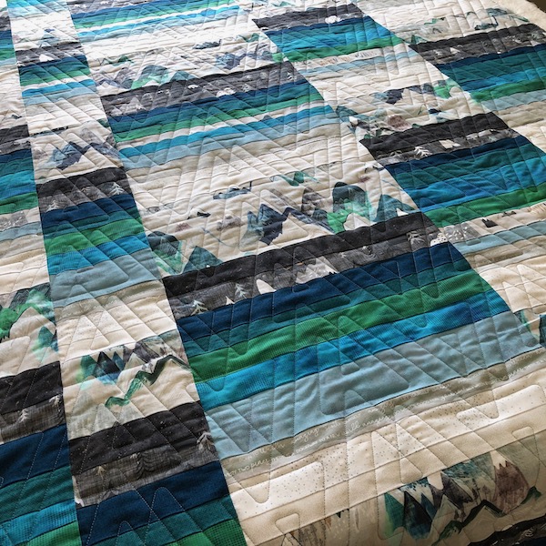 Prism edge to edge quilting design on mountain quilt