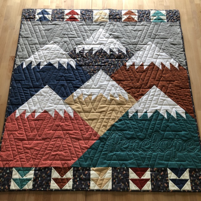 Move Mountains quilt is personalized with Penelope's name.