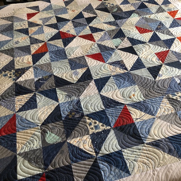 Quilted curves soften angular piecing